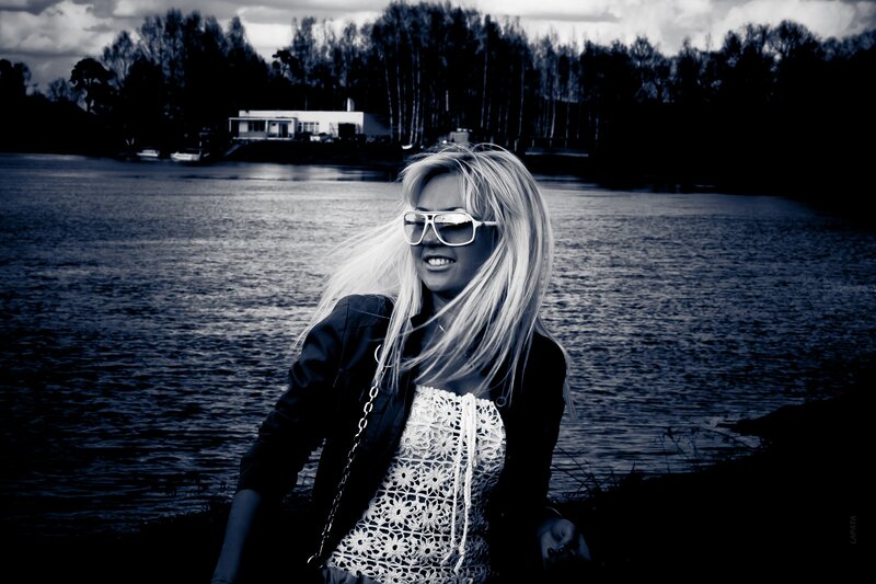 woman by the lake with sunglasses