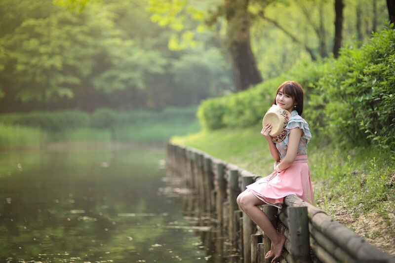 Woman by the pond in spring