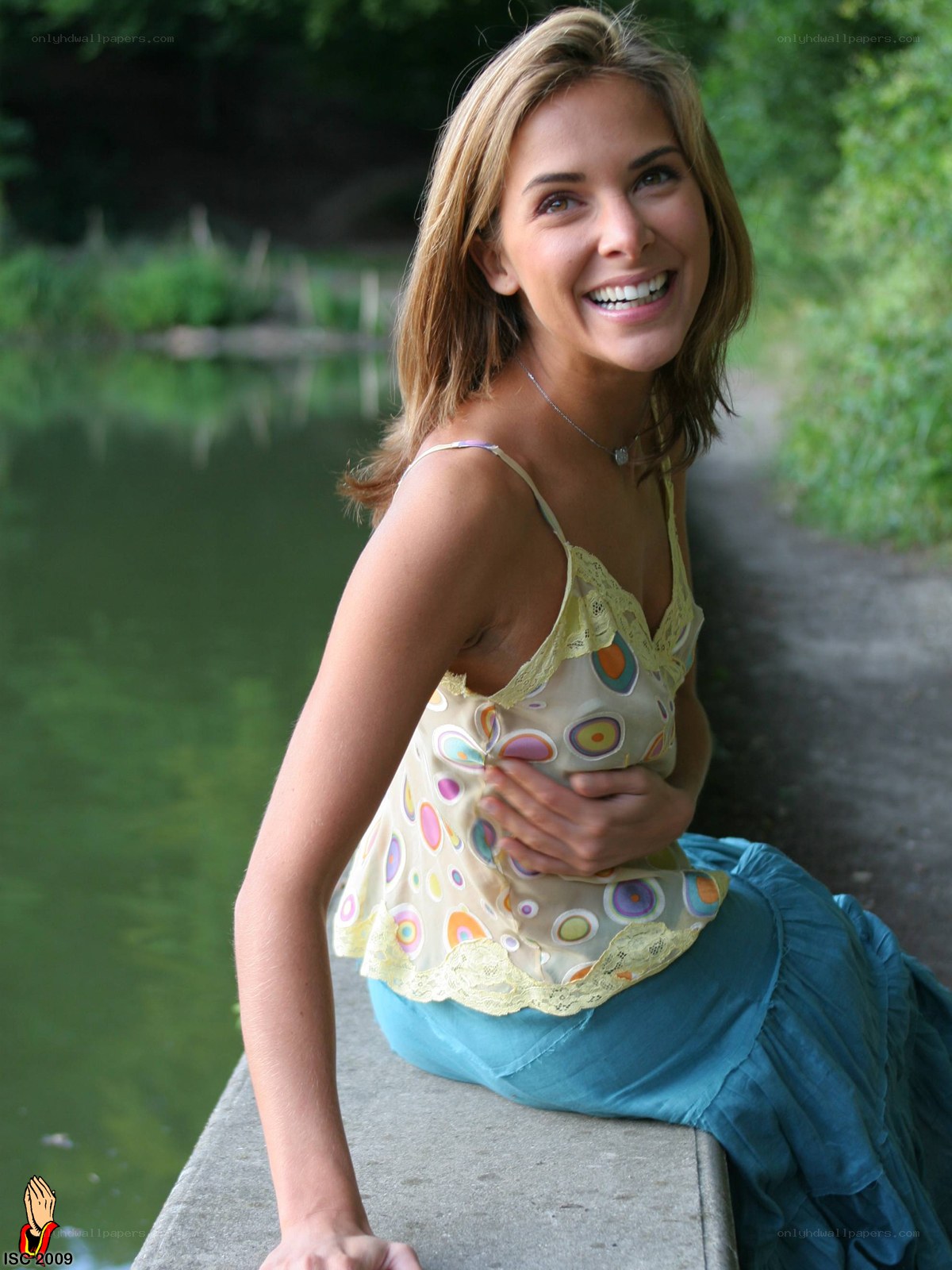 Woman by the pond smiling