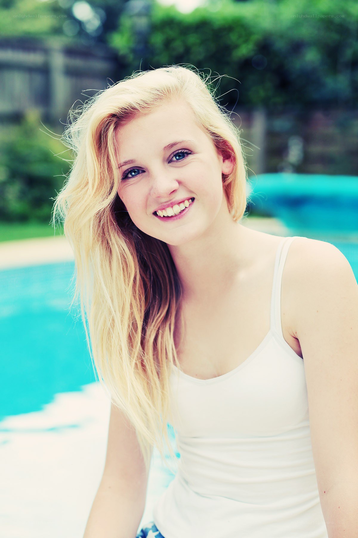 woman by the pool smiling
