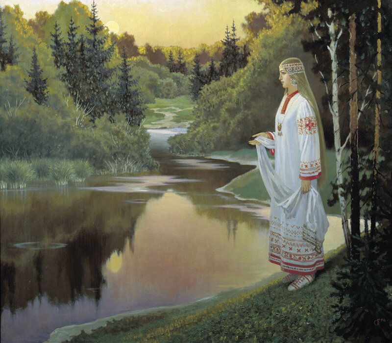 Woman by the river at sunset