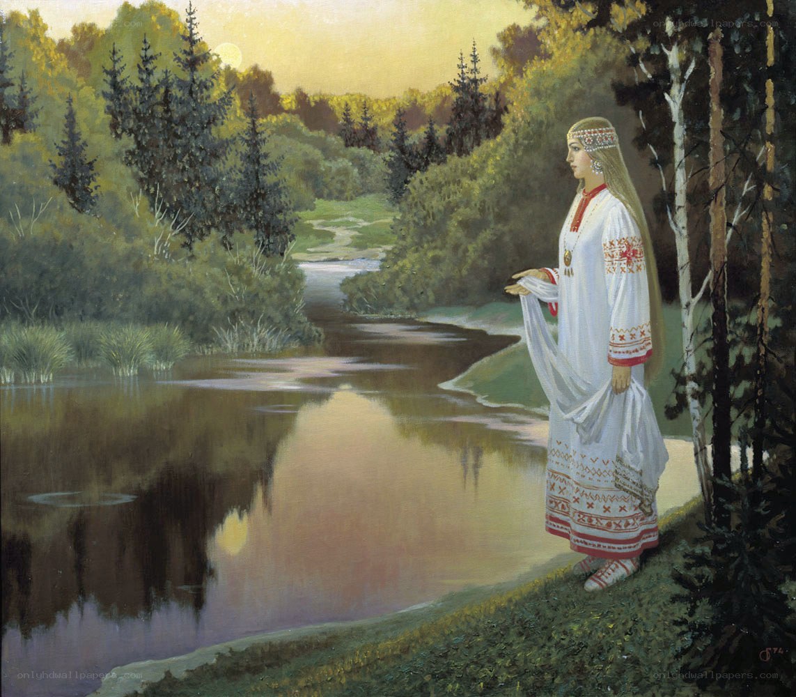 Woman by the river at sunset
