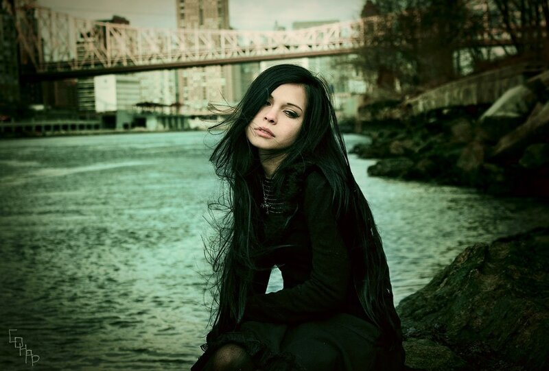 woman by the river with bridge