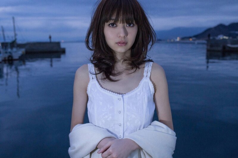woman by the water at dusk