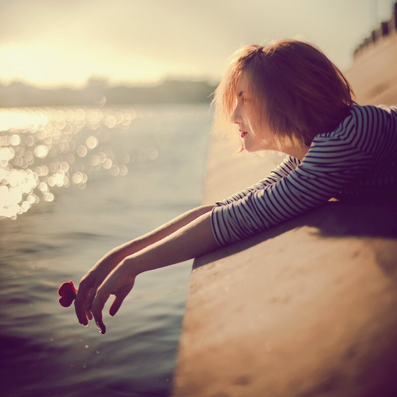 woman by the water at sunset