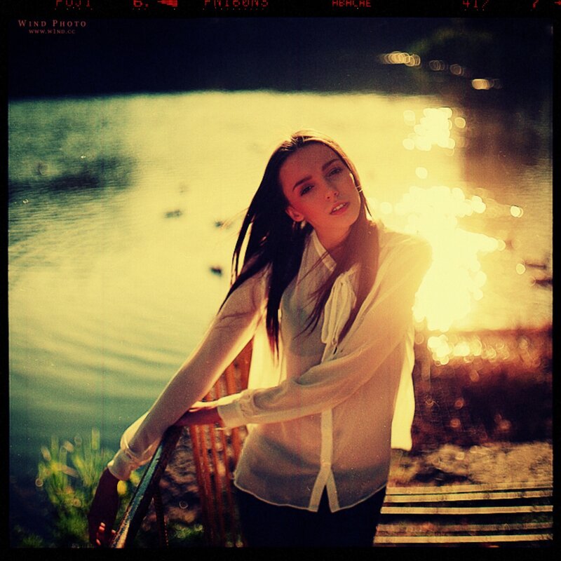 woman by the water at sunset