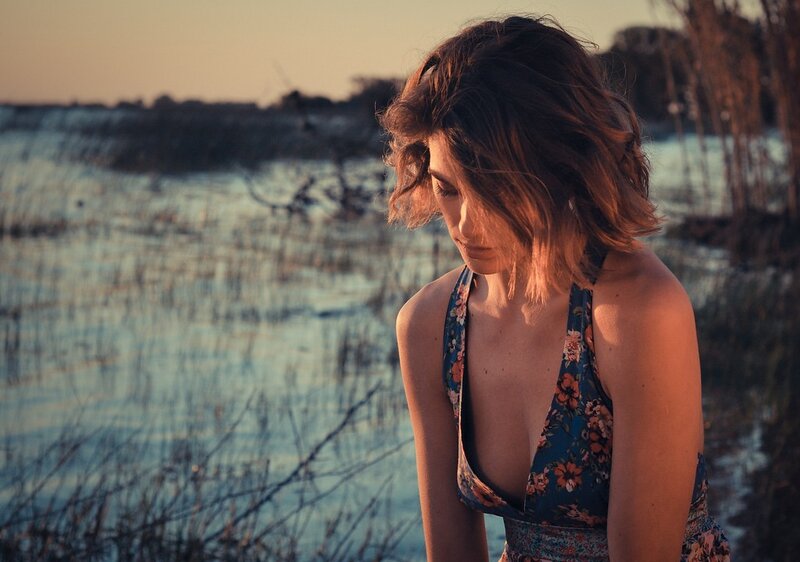 woman by the water at sunset