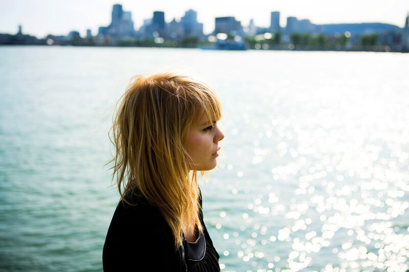 woman by the water with city view
