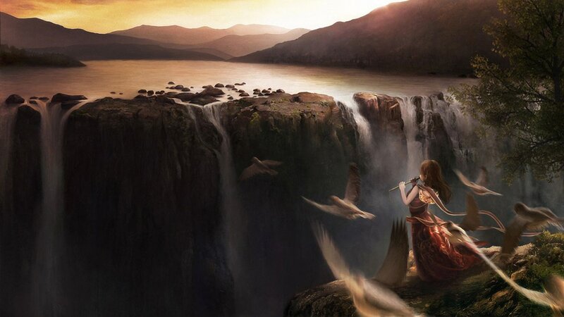 Woman by the waterfall at sunset
