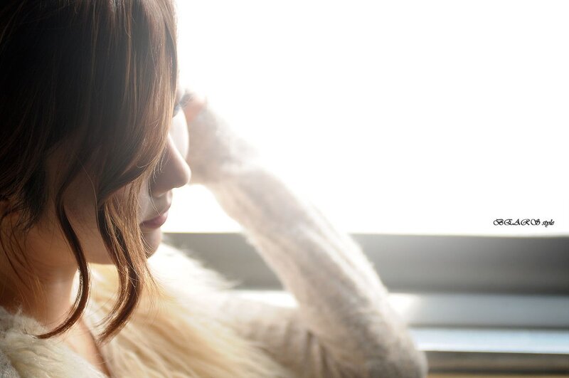 woman by the window in sunlight