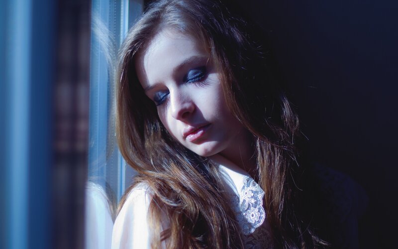 woman by the window in sunlight