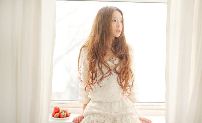 woman by the window with strawberries