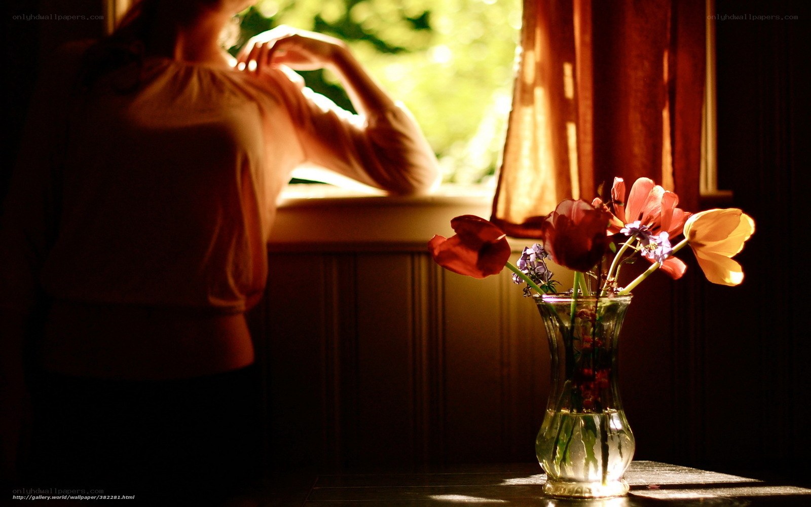 woman by window with flowers