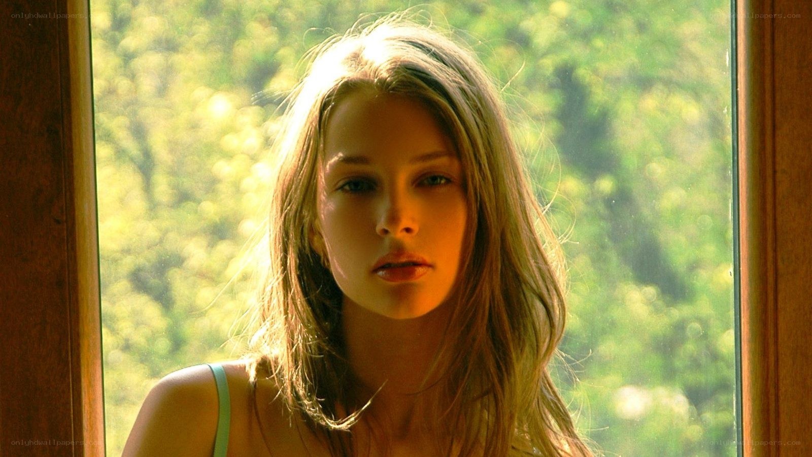 woman by window with sunlight