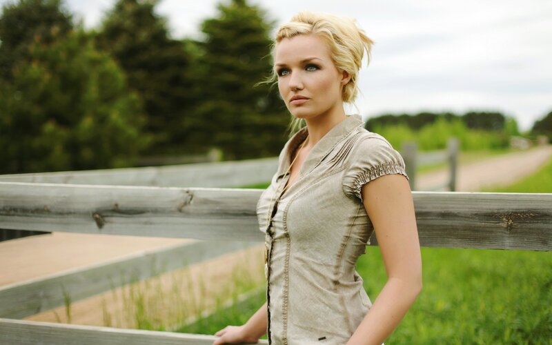 woman by wooden fence