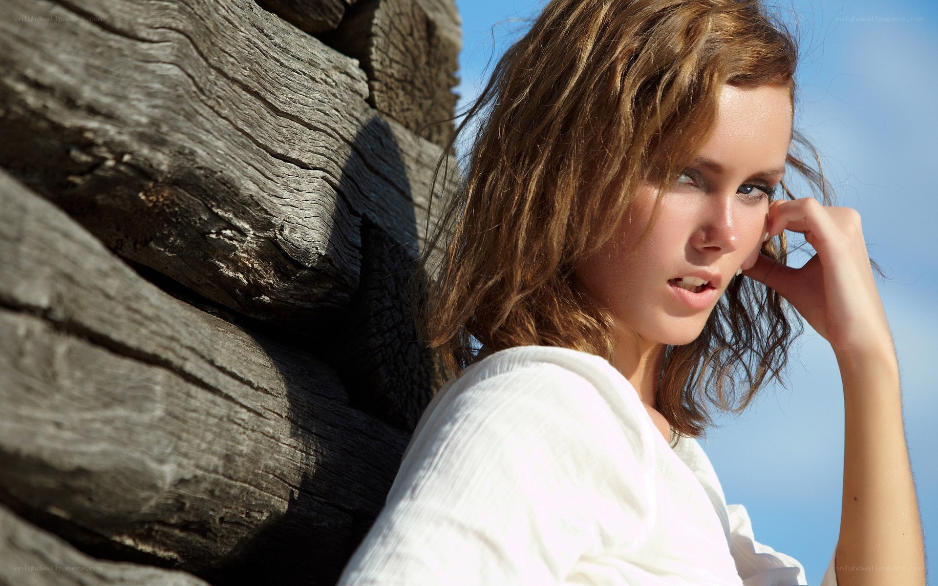 woman by wooden wall