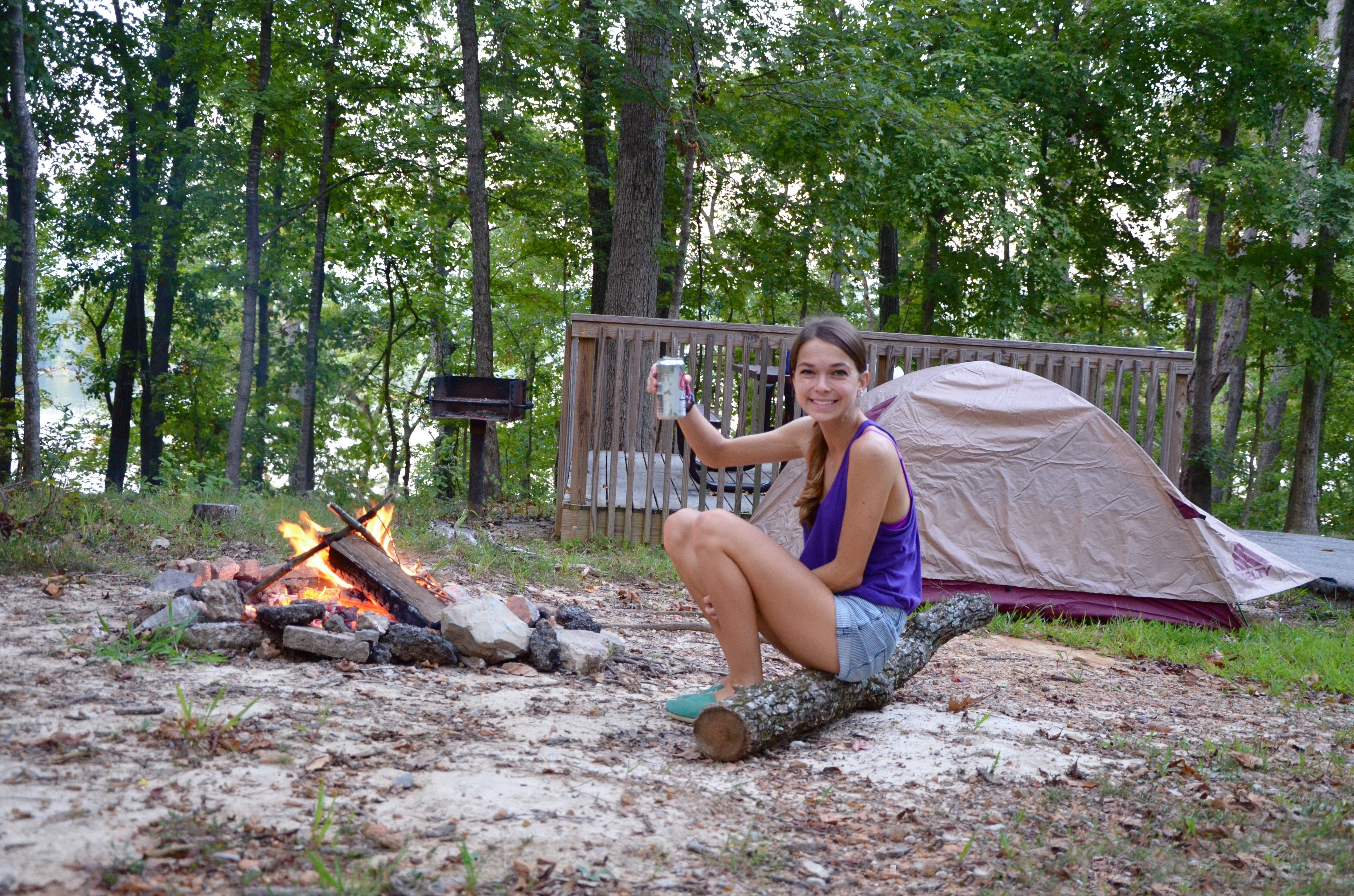 Woman camping by a fire