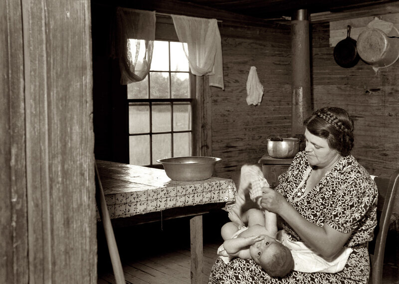 Woman caring for baby in cabin