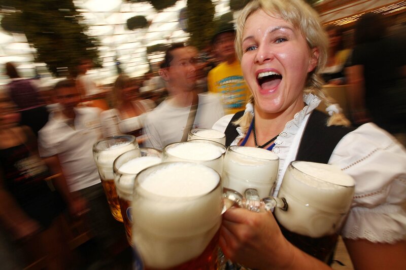 Woman carrying beer mugs