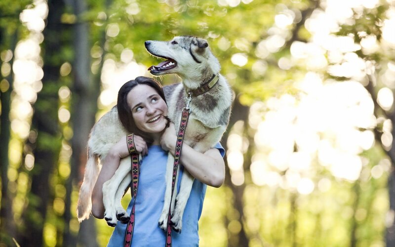 Woman Carrying Dog