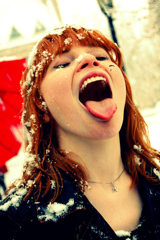 woman catching snow on tongue