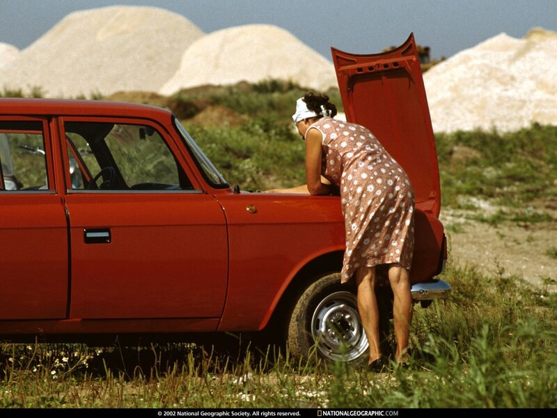 woman checking car engine