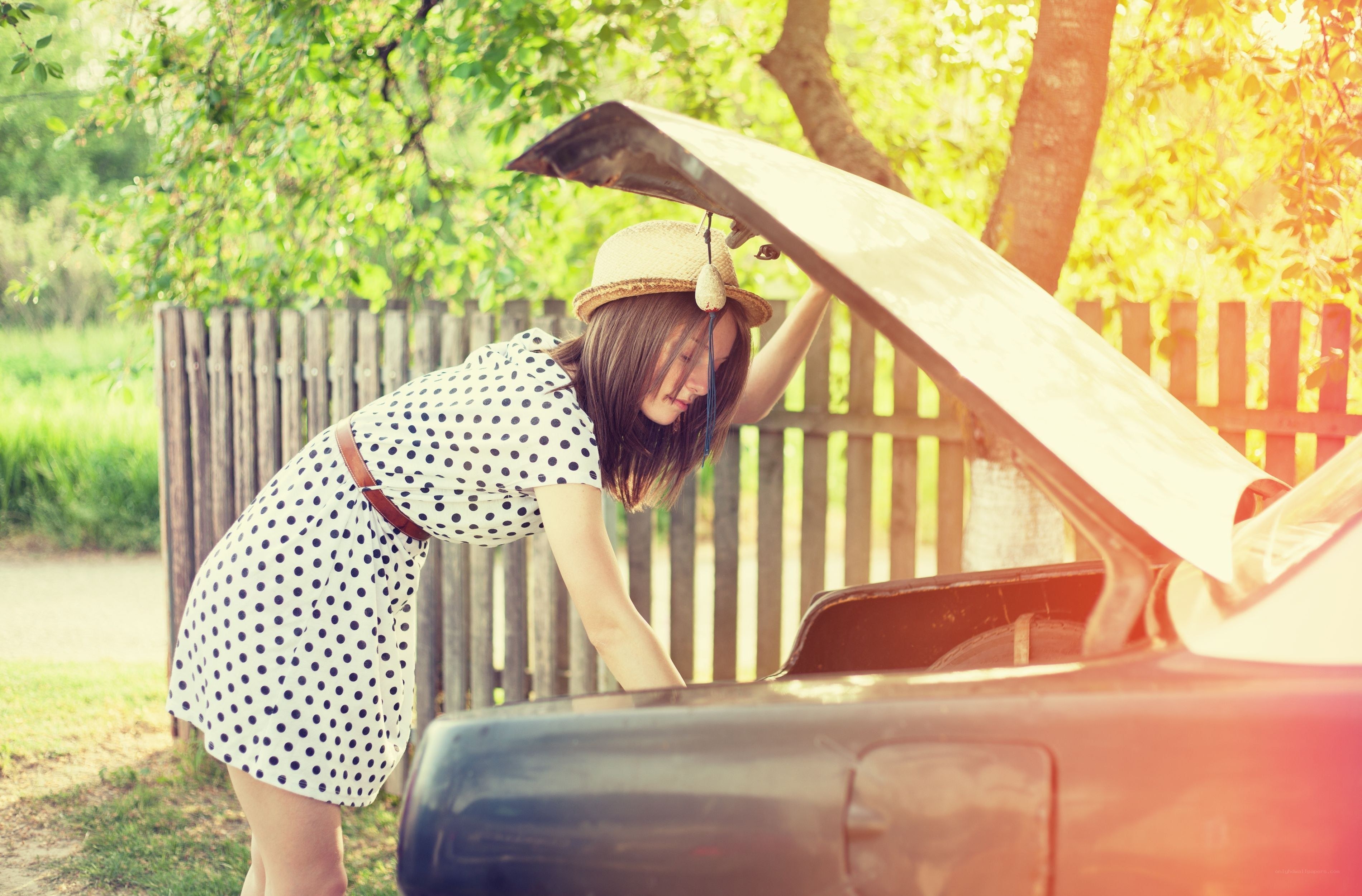 Woman checking car engine