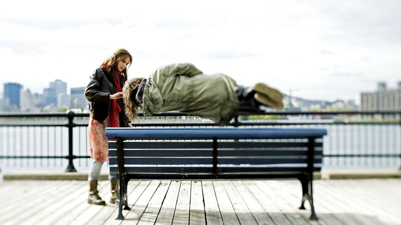 Woman checks on sleeping person
