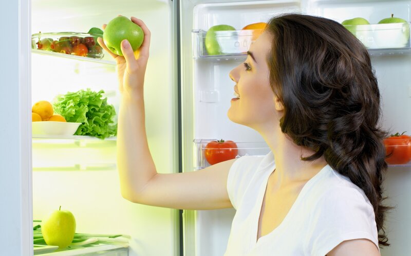 woman choosing green apple
