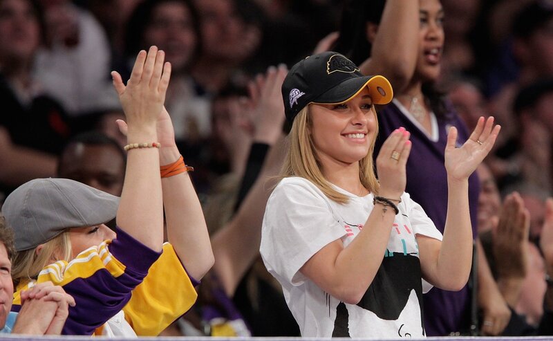 Woman clapping at basketball game