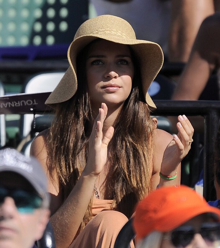 Woman clapping at tennis match
