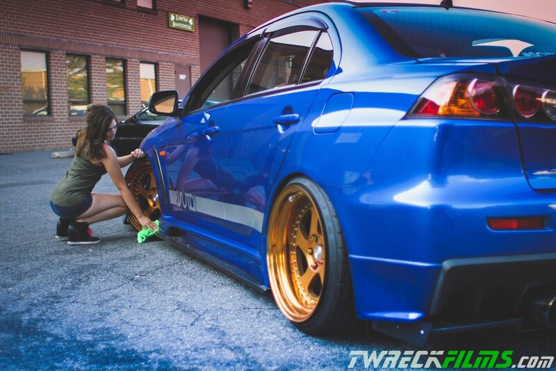 woman cleaning blue car