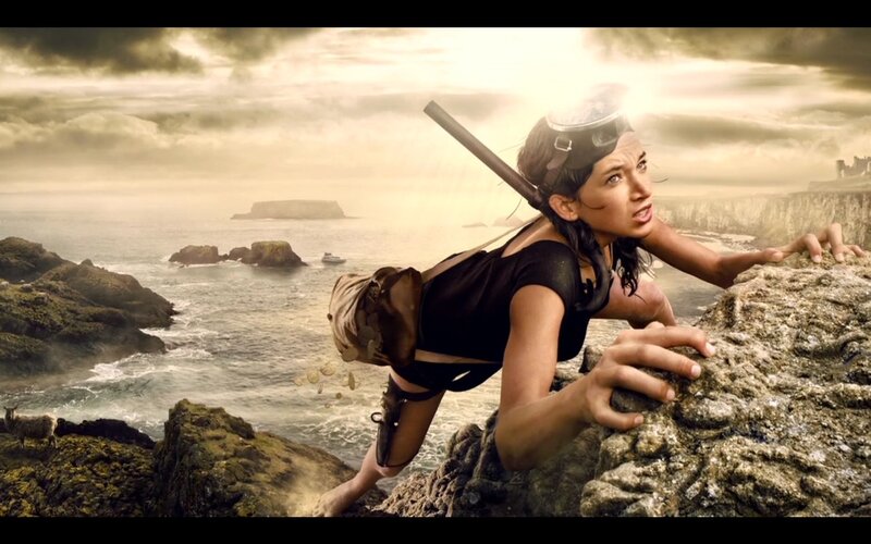 woman climbing rocky cliff