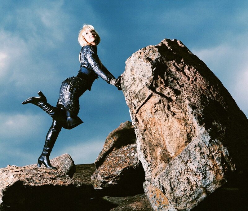 Woman climbing rocky terrain