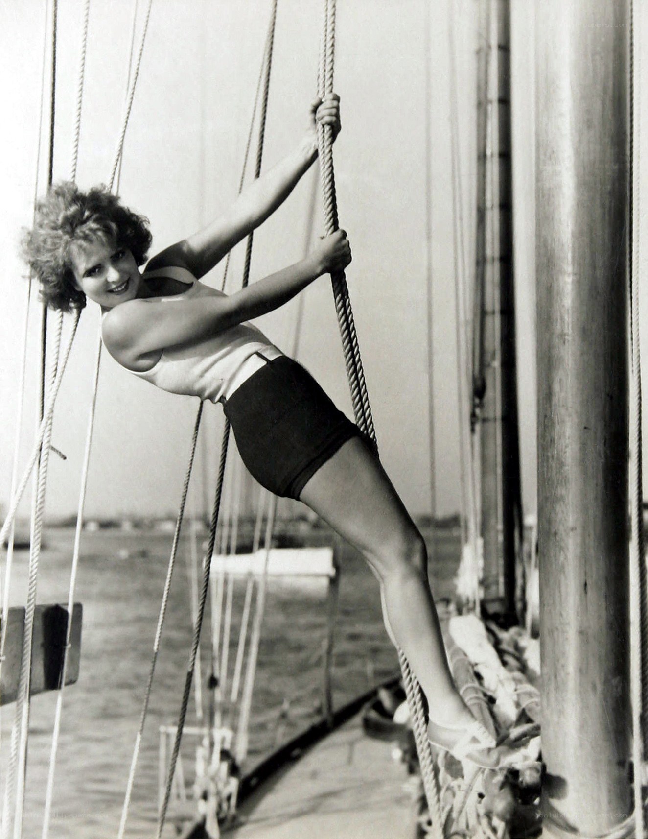 Woman climbing ship rigging