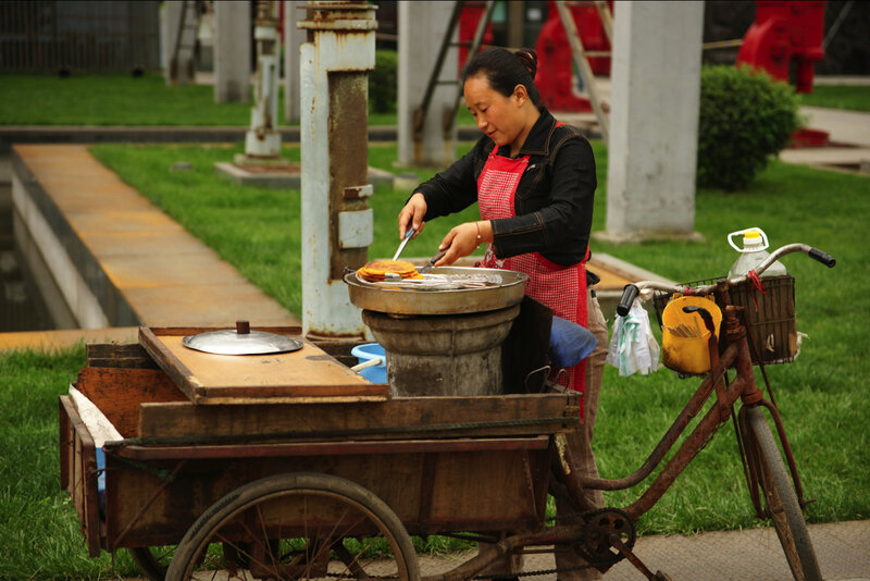 Woman cooking on a cart