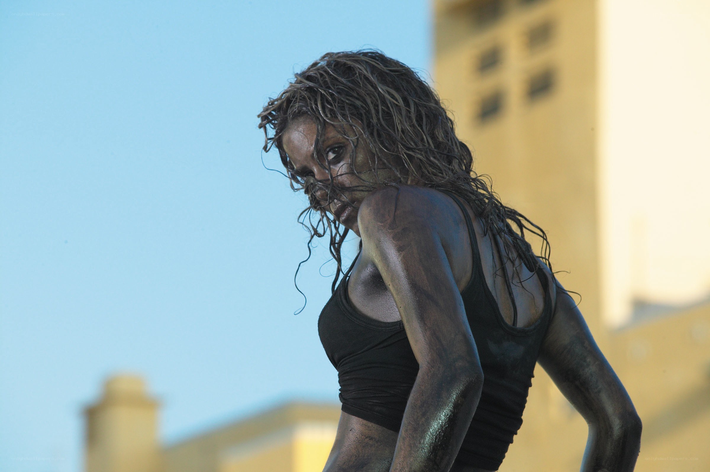 woman covered in mud looking back