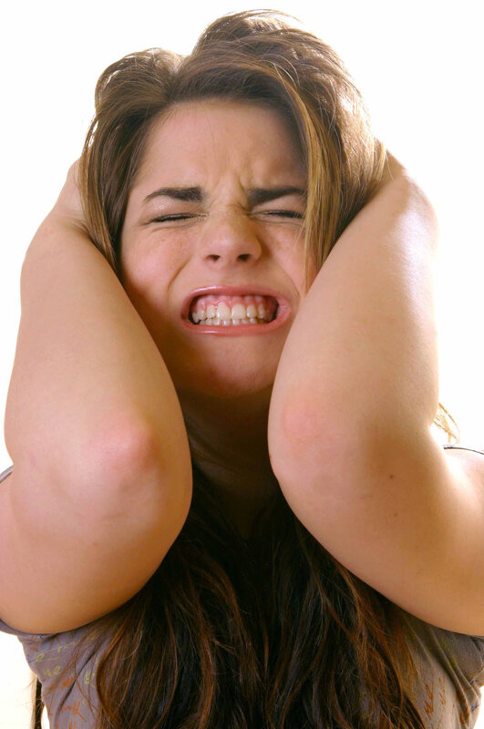 woman covering ears in distress