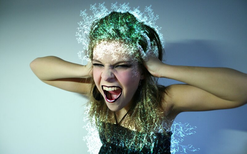 woman covering ears in distress