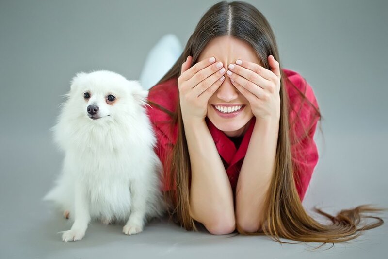 Woman Covering Eyes with Dog