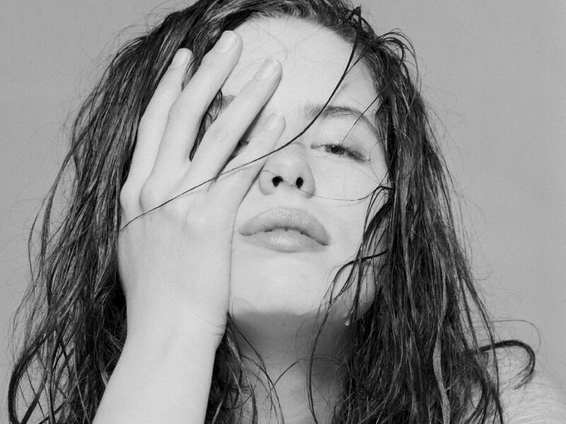 woman covering face with hand