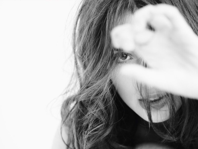 woman covering face with hand