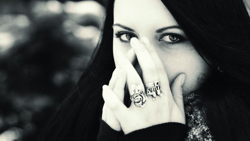 woman covering face with hand