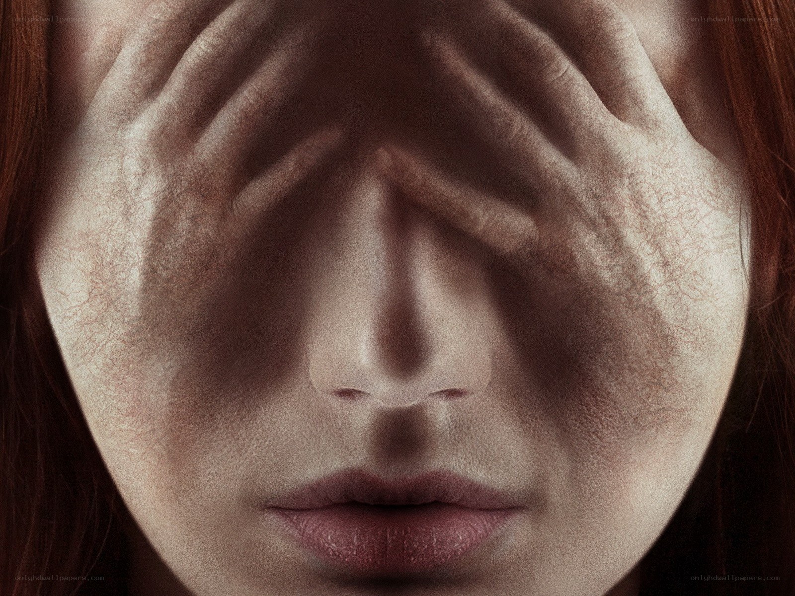 woman covering face with hands