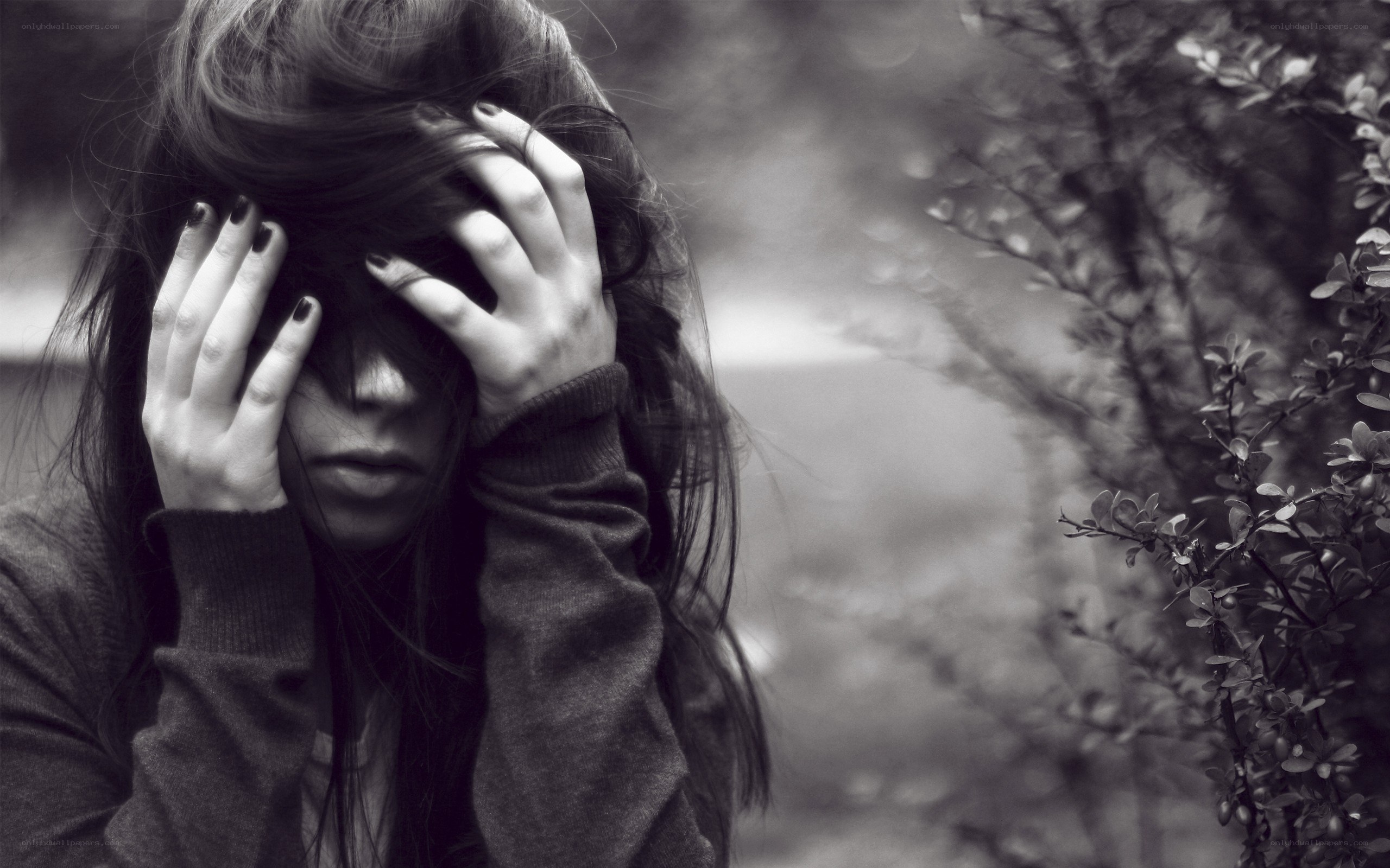 woman covering face with hands
