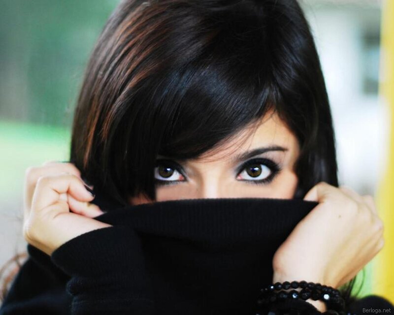 woman covering face with sweater