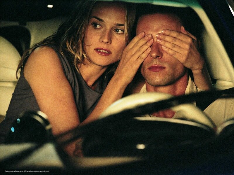 woman covering man's eyes in car