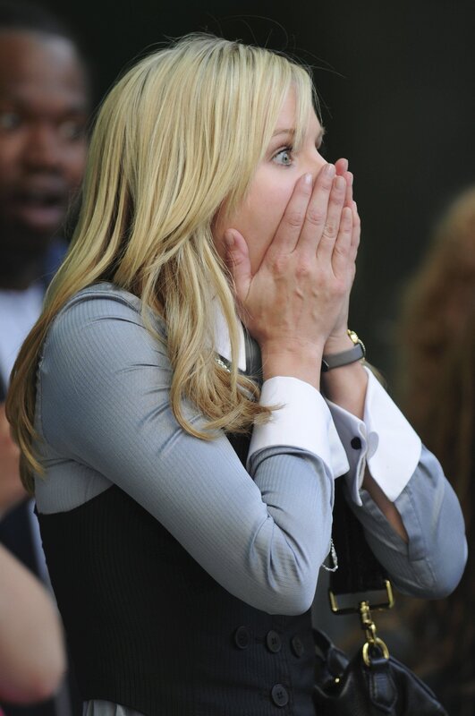 woman covering mouth in surprise