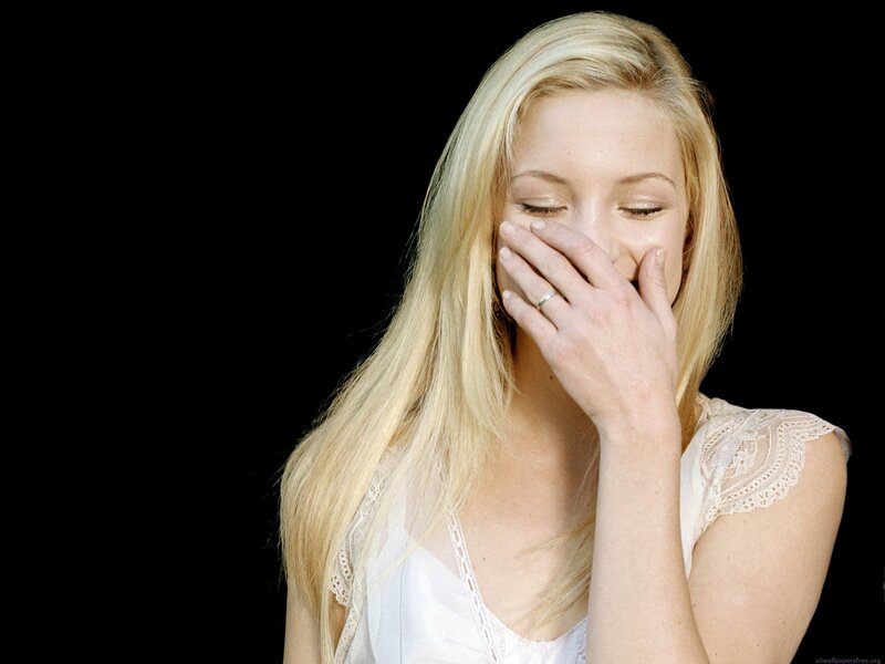 woman covering mouth laughing