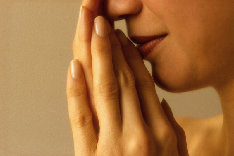 woman covering mouth with hand